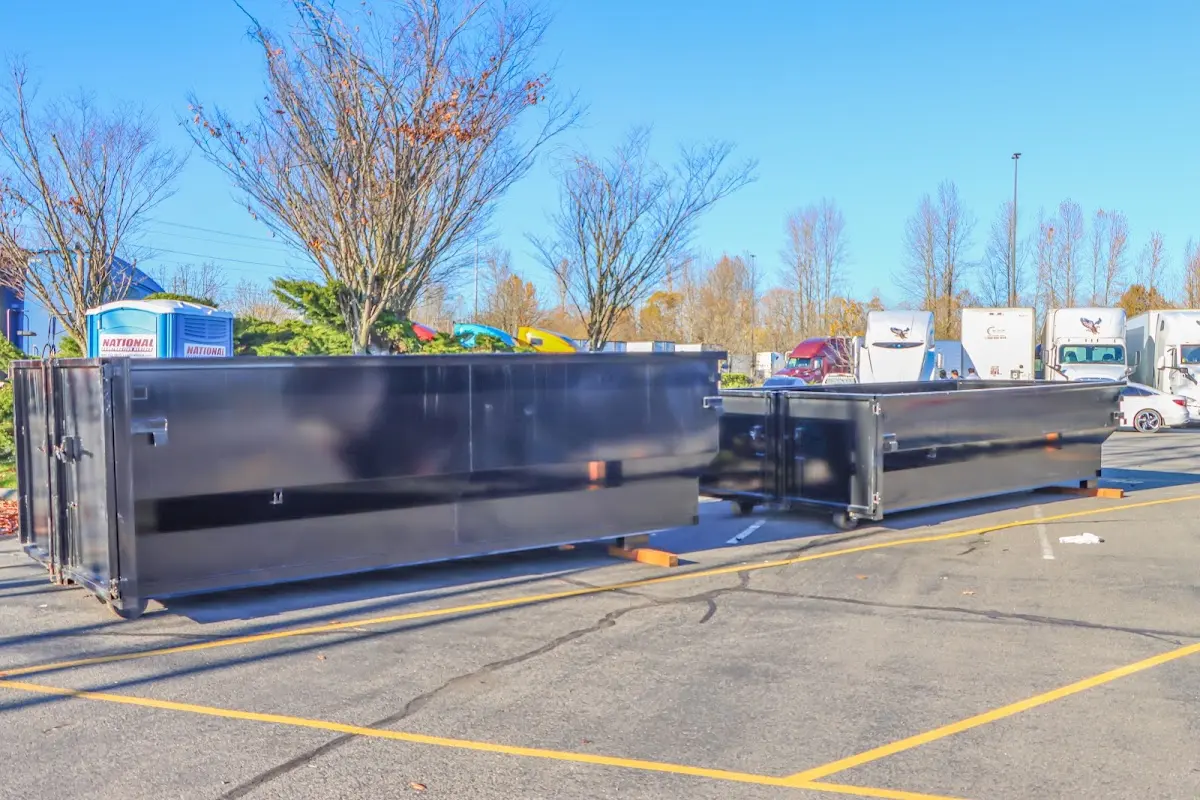 Professional dumpster rental service with roll-off container on residential driveway in Round Lake